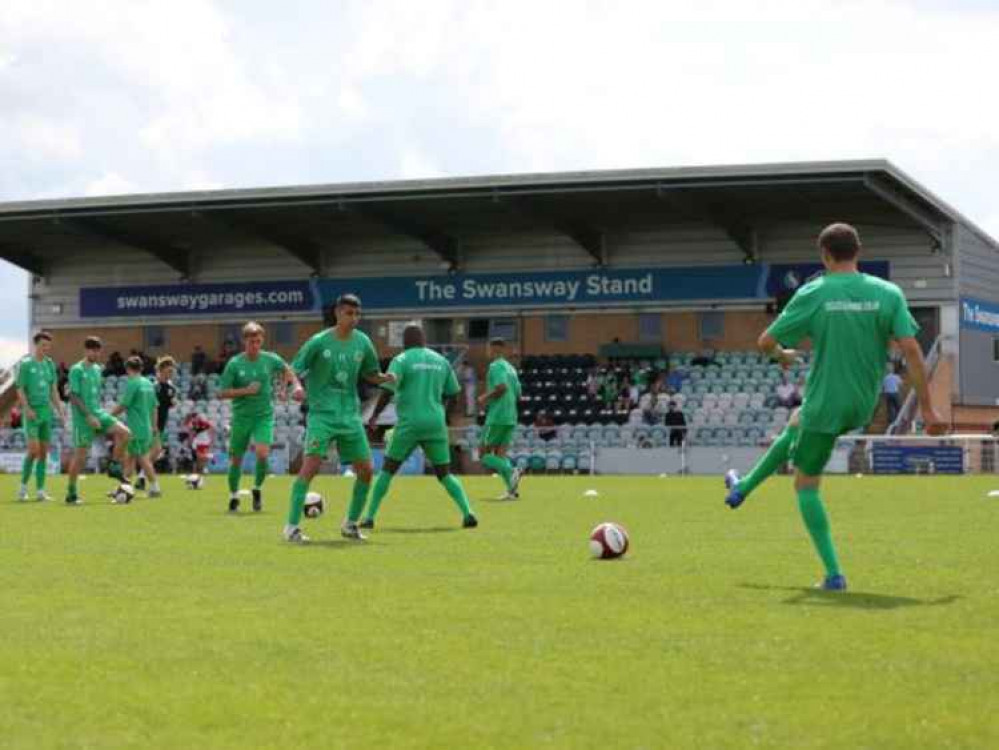 Nantwich Town's players warm-up in front of the newly-named Swansway Stand. Nantwich Town's players warm-up in front of the newly-named Swansway Stand.